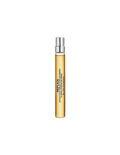 Maison Margiela Replica Eau de Toilette bottle and its white packaging box, featuring a warm amber liquid inside the clear glass bottle.