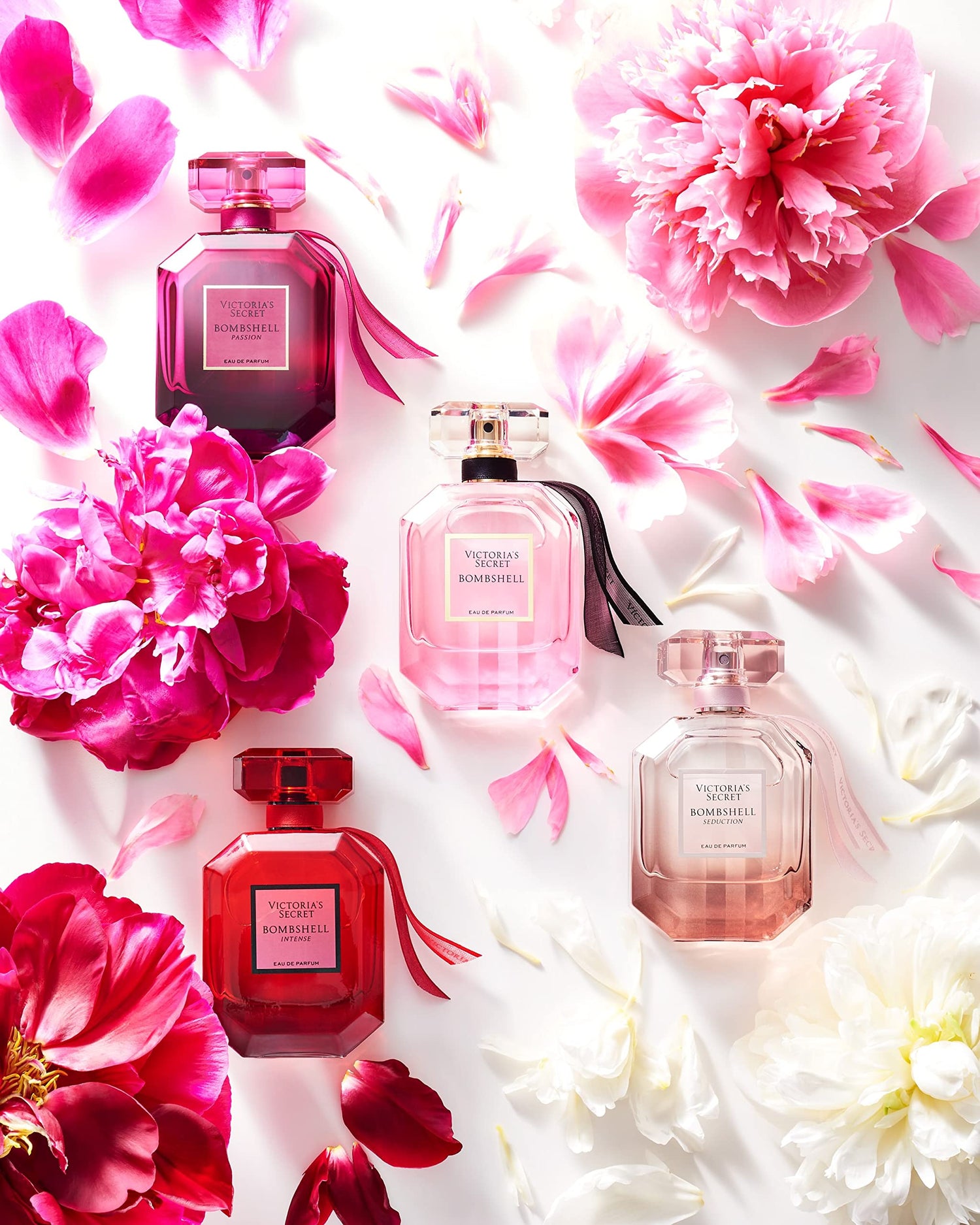 Four perfume bottles on a floral background