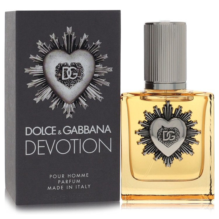 Dolce & Gabbana Devotion Pour Homme perfume bottle with amber liquid and a silver heart emblem, shown next to its dark gray packaging box with matching heart design.