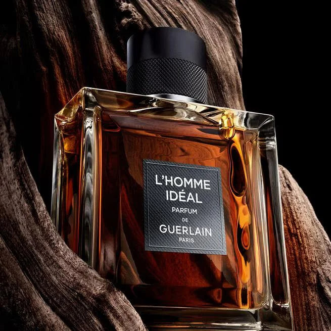 Guerlain L'Homme Ideale parfum bottle with wooden background