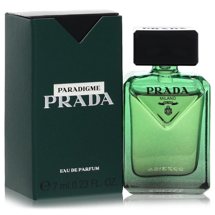 Prada Paradigme Eau de Parfum 7ml bottle in green glass next to its dark green packaging box on a white background.